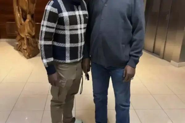 Nigerian football president Ibrahim Gusau checks on Moses Simon's recovery in France