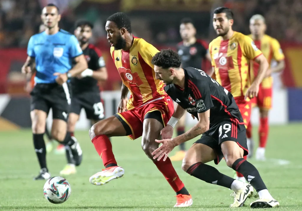 Roger Ben Boris Aholou Of Esperance Tunis Challenged By Wessam Abou Ali Of Al Ahly During The Caf Champions League 2023 24 1st Leg Final Match Between Esperance Tunis And Al Ahly