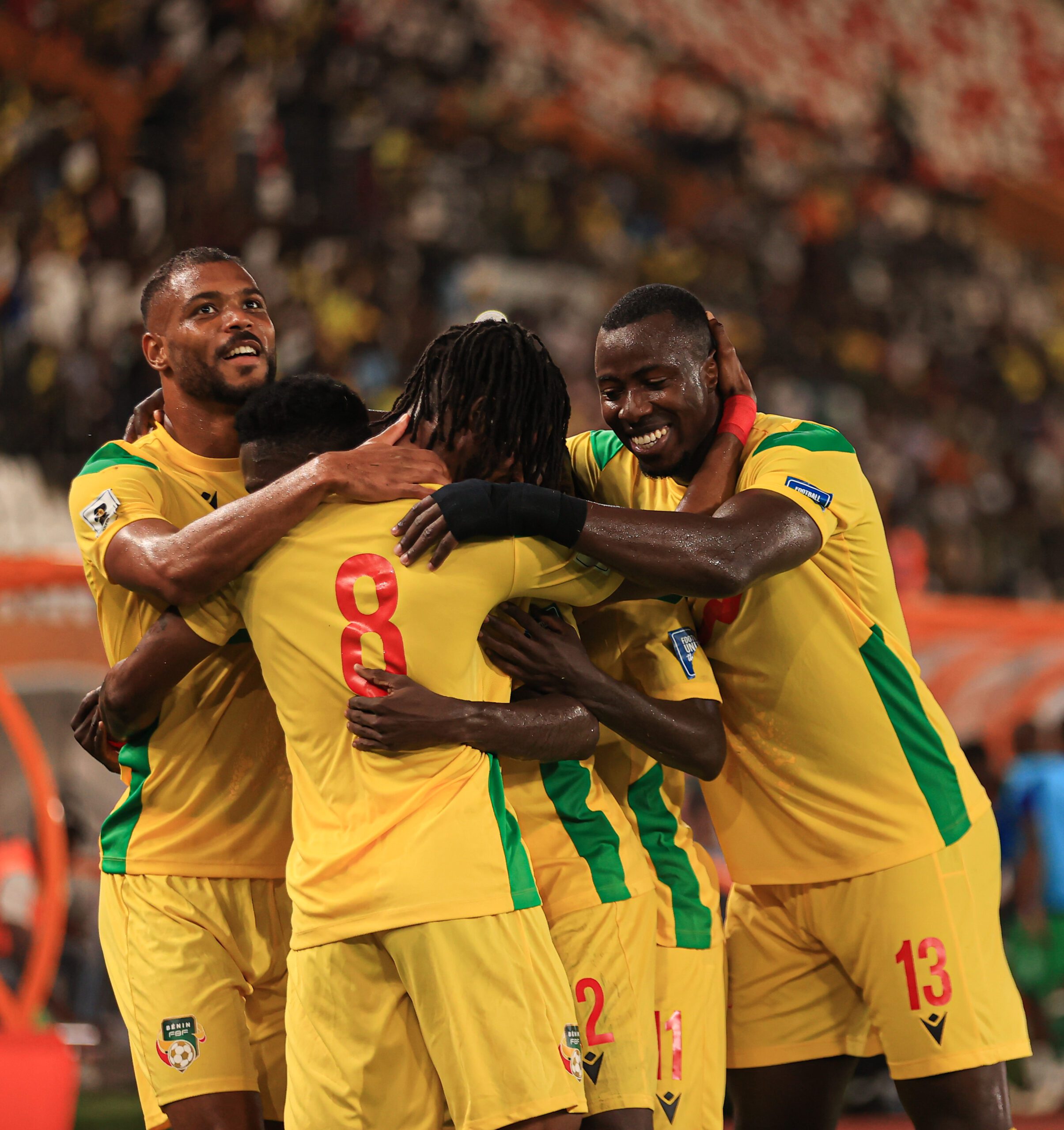 Benin players celebrating after scoring against Rwanda