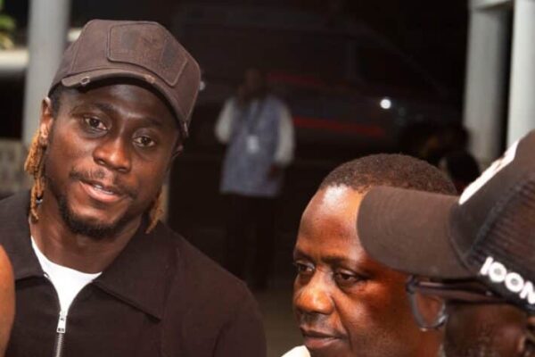 Guinea FGF stands with Issiaga Sylla after arrival of his late wife’s body in Conakry