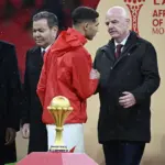 Hakimi walks past AFCON trophy