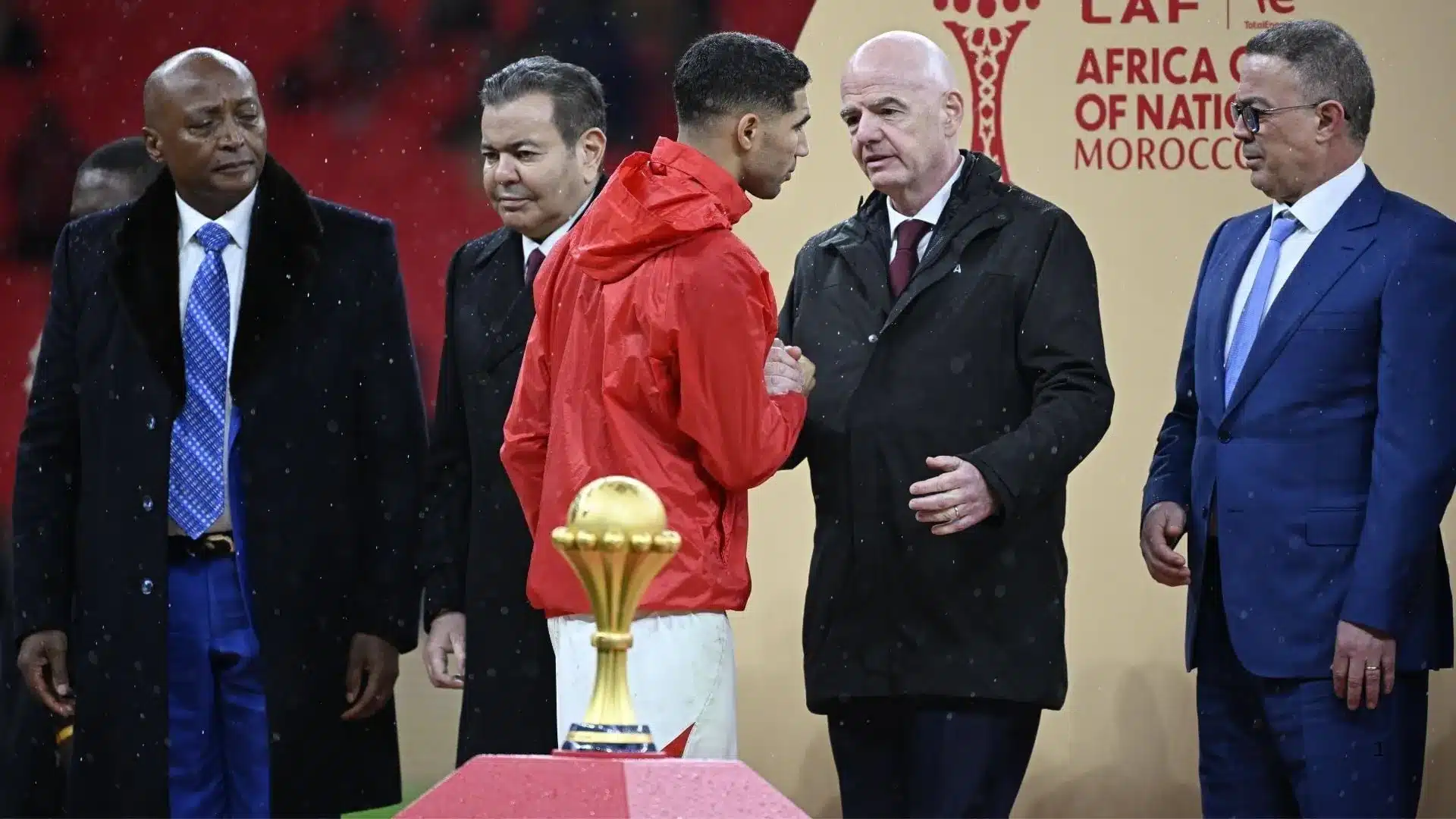 Hakimi walks past AFCON trophy