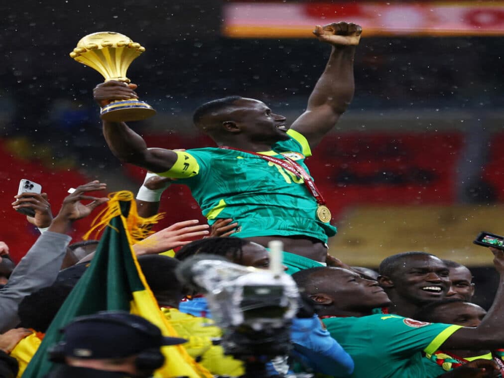 Senegal players celebrating with AFCON trophy