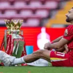 Mohamed Salah celebrating Premier League and Champions League titles with Liverpool