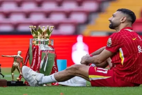 Mohamed Salah celebrating Premier League and Champions League titles with Liverpool