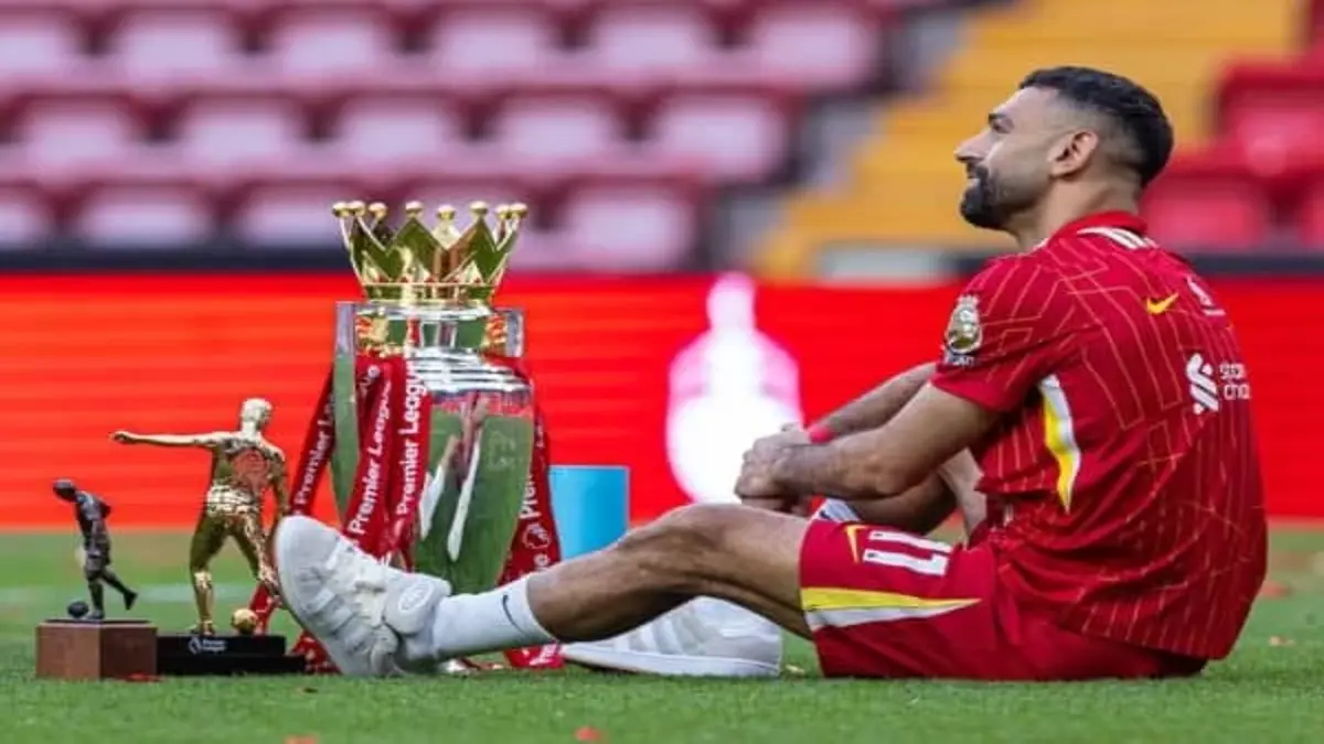 Mohamed Salah celebrating Premier League and Champions League titles with Liverpool