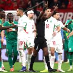 Morocco and Senegal Football players arguing on the field in the AFCON final