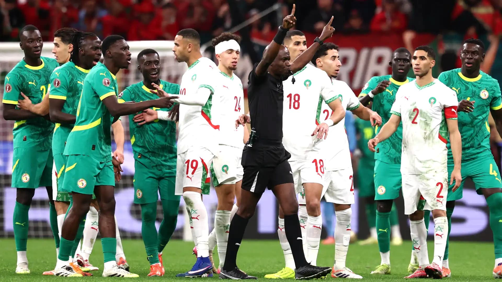 Morocco and Senegal Football players arguing on the field in the AFCON final