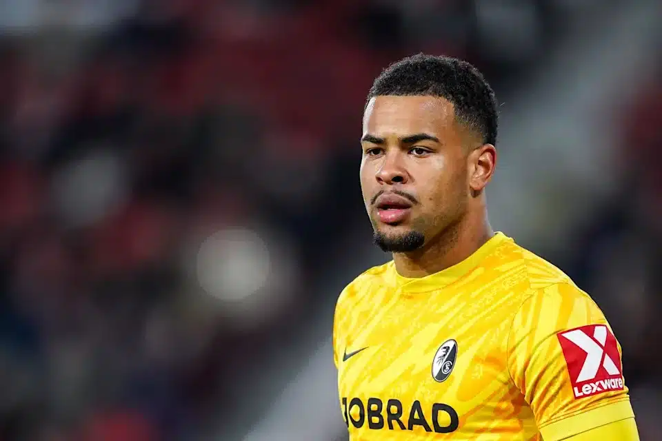 Noah Atubolu celebrates after saving a penalty for Freiburg