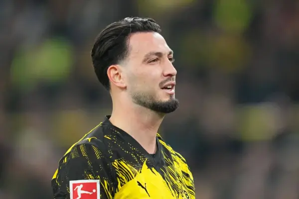 Ramy Bensebaini reacts after mistake in Dortmund match
