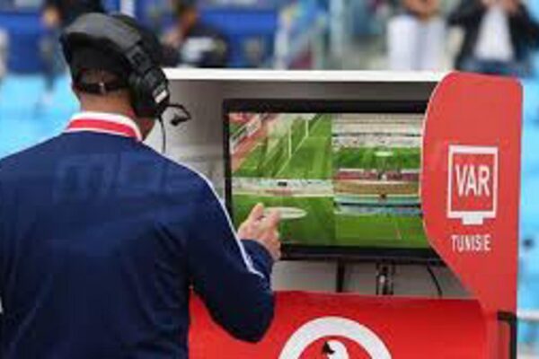 VAR official reviewing footage during a football match