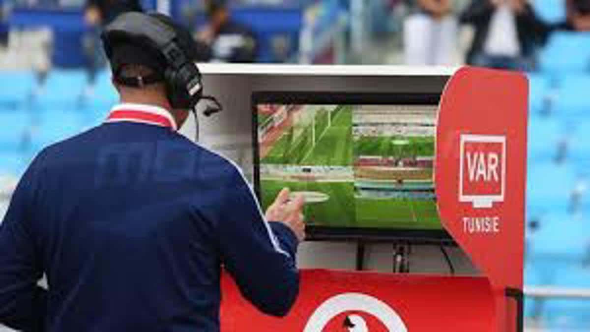 VAR official reviewing footage during a football match