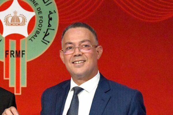 Morocco players celebrate with Fouzi Lekjaa after qualification