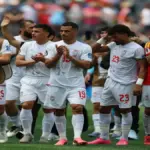 Iran players react while watching the Algeria vs Austria World Cup match.