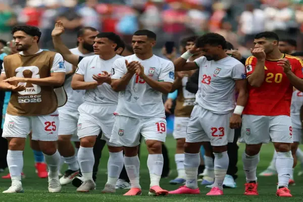 Iran players react while watching the Algeria vs Austria World Cup match.