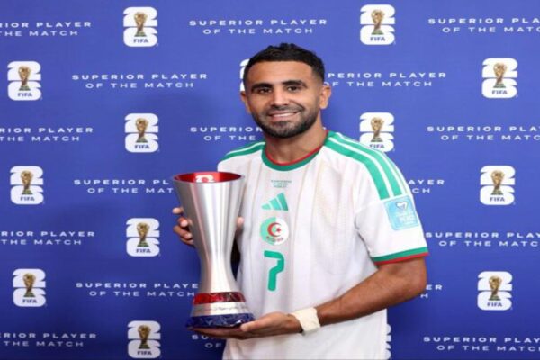 Riyad Mahrez holds the FIFA Man of the Match trophy after Algeria's World Cup match against Austria.