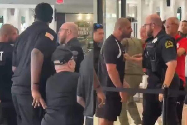 Egypt officials react after a police incident involving a young fan outside the team's hotel in Dallas.